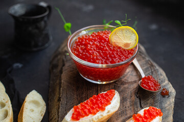 Red caviar on a dark background. Sandwiches with caviar