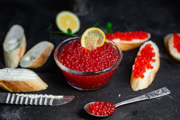Red caviar on a dark background. Sandwiches with caviar