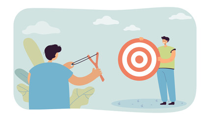 Male character catapulting at target that his friend holding. Man aiming at shooting mark from slingshot flat vector illustration. Goal achievement concept for banner, website design, landing web page