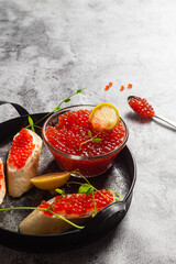 Red caviar on a dark background. Sandwiches with caviar
