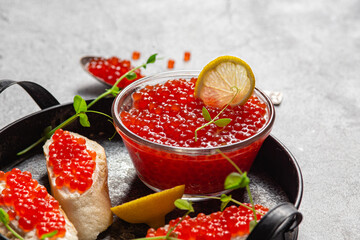 Red caviar on a dark background. Sandwiches with caviar