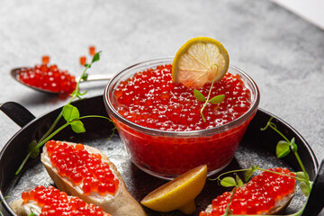 Red caviar on a dark background. Sandwiches with caviar
