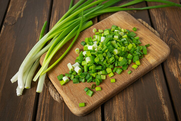 spring onion sliced for salad or seasoning on wooden surface - 476412399