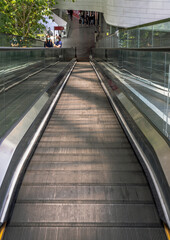 Bangkok, Thailand - Apr 16, 2021 : Modern escalator with people for facilities in a contemporary building. No focus, specifically.