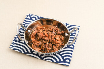 Slice beef with teriyaki sauce in small pan. Asian style food. Copy space.
