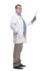 in full growth. serious doctor looking at an x-ray.