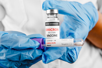 covid 19 OMICRON Variant vaccine in hand on the white background.