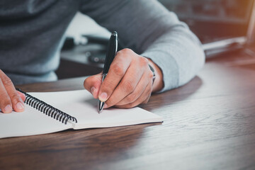 Close-up of Hand using writing pen with questionnaire or paperwork survey question filling in...