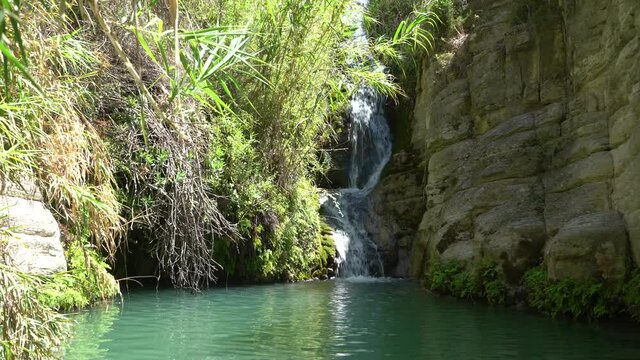 Cyprus, Paphos - August 2021: Adonis Baths Waterfalls. A two-level waterfall with a natural pool and statues of Adonis and Aphrodite.