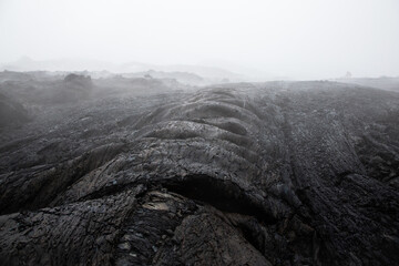 Congealed swollen rope volcanic lava. Dark background. Far East. Tolbachik plateau.
