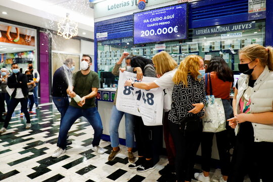 Lottery management owners celebrate having sold the first prize, in Las Palmas de Gran Canaria