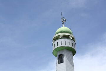 mosque tower against blue sky