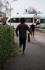 a guy running with a train in the background