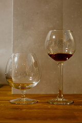 A glass of elite cognac on the bar. Wooden table background. Hard strong alcoholic drinks, spirits and distillates in glasses: vodka, cognac, tequila, scotch, brandy and whiskey, grappa, vermouth, rum