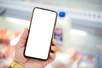 Scanning product Via phone doing grocery shopping in supermarket store.