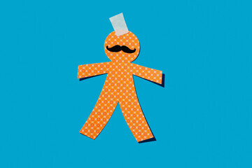 cutout paper man doll with a moustache