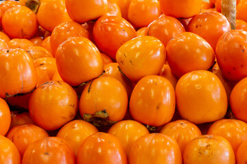 Close Up of Group of Persimmon Apples in Italian Market