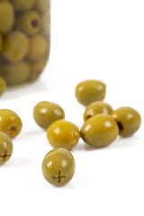 Green olives on a white background. Olives on a white background. Top view. Pitted green olives on white background. Close up.