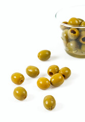 Green olives on a white background. Olives on a white background. Top view. Pitted green olives on white background. Close up.