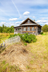 Fototapeta na wymiar Abandoned rural wooden house in russian village in summer