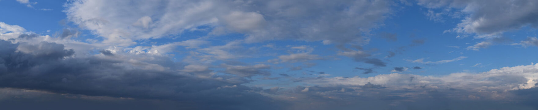 Late evening, impending, powerful thunderclouds.
Panoramic photography, the image is horizontally elongated, atmospheric phenomenon.
