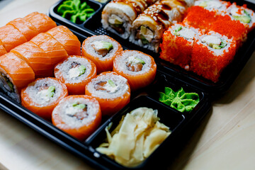 Japanese sushi food. Maki ands rolls with tuna, salmon, shrimp, crab and avocado. Top view of assorted sushi. Rainbow sushi roll, uramaki, hosomaki and nigiri.