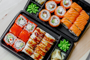 Japanese sushi food. Maki ands rolls with tuna, salmon, shrimp, crab and avocado. Top view of assorted sushi. Rainbow sushi roll, uramaki, hosomaki and nigiri.