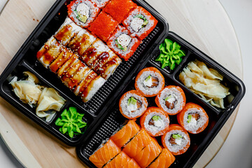 Japanese sushi food. Maki ands rolls with tuna, salmon, shrimp, crab and avocado. Top view of assorted sushi. Rainbow sushi roll, uramaki, hosomaki and nigiri.