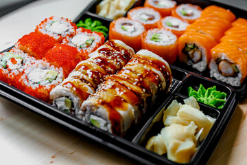 Japanese sushi food. Maki ands rolls with tuna, salmon, shrimp, crab and avocado. Top view of assorted sushi. Rainbow sushi roll, uramaki, hosomaki and nigiri.