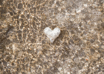 White heart underwater on a sandy beach. Beautiful sun glare. I love summer, vacation, travel,...