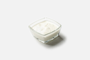 Sour cream sauce with a glass bowl on a white background for insulation