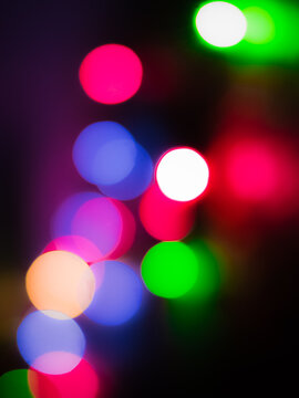 Portrait view of out of focus decoration color lights .Circle bokeh shapes wallpaper or background for texts, images and articles, blank space with blurred background.Christmas light.