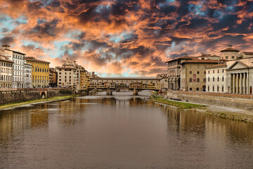 sunset in the town of florence with bridge