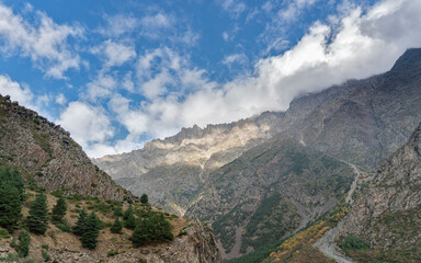 Fototapeta na wymiar Mountain landscape panorama. A beautiful gorge on a sunny day, bright blue sky with fluffy white clouds.