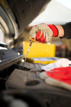car mechanics check car engine oil