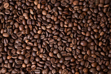 Coffee bean background. Roasted coffee beans on a wooden table. Brown coffee. Top view