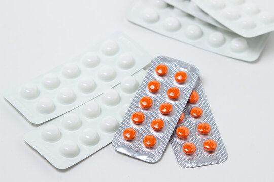 Pills in plates on a white background. Treatment with medication. Health care