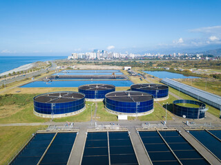 Drone view of sewage treatment plants, filtration of dirty or waste water near the sea. Stage of...