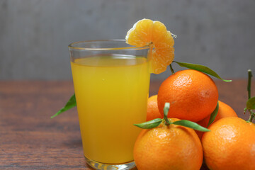 fresh organic tangerine juice in a glass bowl on a wooden base