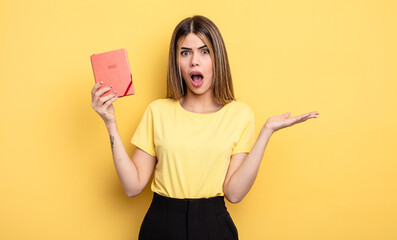 pretty woman amazed, shocked and astonished with an unbelievable surprise. planner concept
