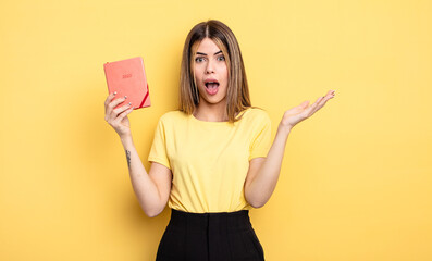 pretty woman feeling extremely shocked and surprised. planner concept