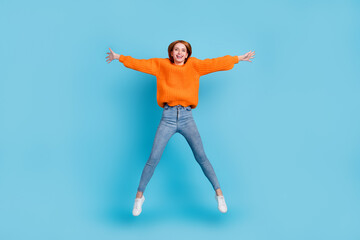 Fototapeta na wymiar Full length body size view of pretty cheerful girl jumping having fun isolated over bright blue color background