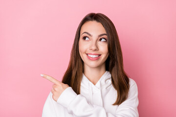 Photo of charming young positive woman look point finger empty space sale isolated on pink color background