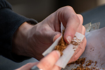 close up of a hand holding a cigarette