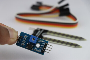 Analog to digital signal converter for soil moisture detection sensor with sensor and wires on the...