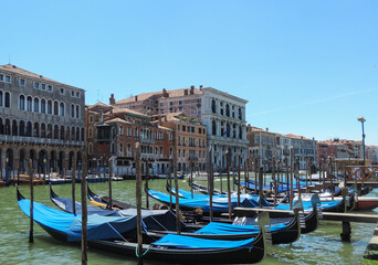 Fototapeta na wymiar Venice, Italy, July 2017 - view of some gondolas harbored at the Grand Canal 