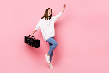 Full length photo of funky young brunette lady with boom box dance wear white hoodie jeans isolated on pink color background