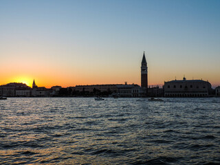 Fototapeta na wymiar View of the Doge's Palace and Venice's bell tower during a beautiful sunset - Venice, Italy