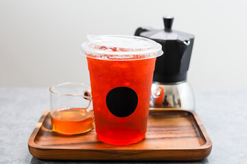 Iced honey black tea in plastic cup.