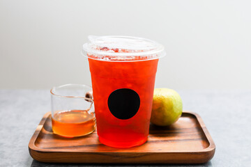 Iced black tea in plastic cup.